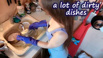 Washing dishes with purple rubber gloves