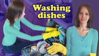 Washing dishes in purple rubber gloves and white shirt #1