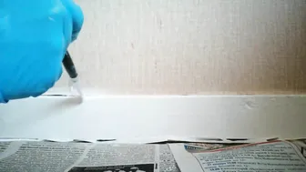 Painting the baseboard in blue latex gloves #5